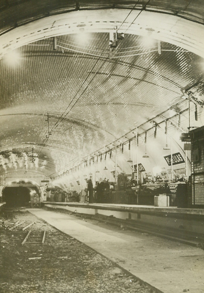 PARIS FACTORY SERVED AS NAZI FACTORY, 9/23/1944.FRANCE – During aerial attacks on the French capital, German officials sealed off the two and one-half miles of the Paris subway system and moved the remnants of the German aircraft industry in that area into this shelter deep underground.  With the taking of Paris officials discovered $15,000,000 worth of machines to make propeller crankshafts in the Porte of Lillas station.  This is a view of the subway with the vital machines on a platform at right and concrete laid along one-half of the area formerly occupied by tracks.Credit: Acme;