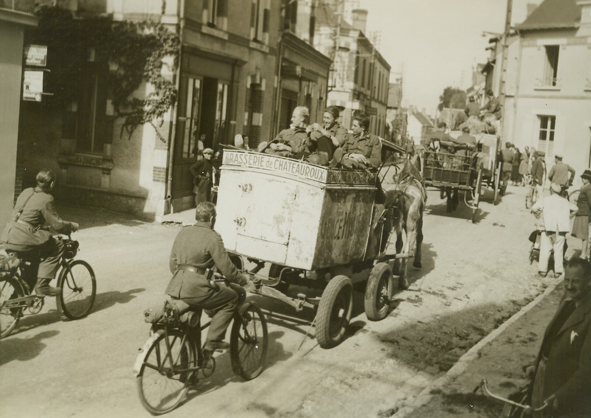 TAKE A RIDE TO PRISON, 9/23/1944. FRANCE—German soldiers ride on ice cream carts, bicycles and wagons as they head for Beaugency to give themselves up after surrender which led to the capture of 20,000 Nazis without the loss of a single American soldier. Photo by Acme photographer, Charles Haacker, for the War Picture Pool. Credit-WP-(ACME);