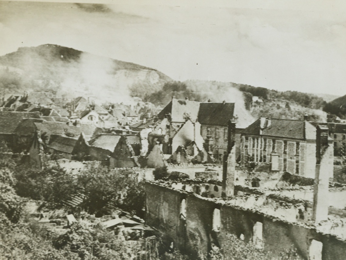 Now It’s the Nazis’ Turn, 9/13/1944. France -- Withdrawing in the face of relentlessly advancing Allied forces, German troops are reverting to the scorched earth policy in many sections of France. Buildings were gutted and still burning in the town of Baume les Dames as American troops entered hot on the heels of the retreating Nazis. Credit: Army photo from ACME;