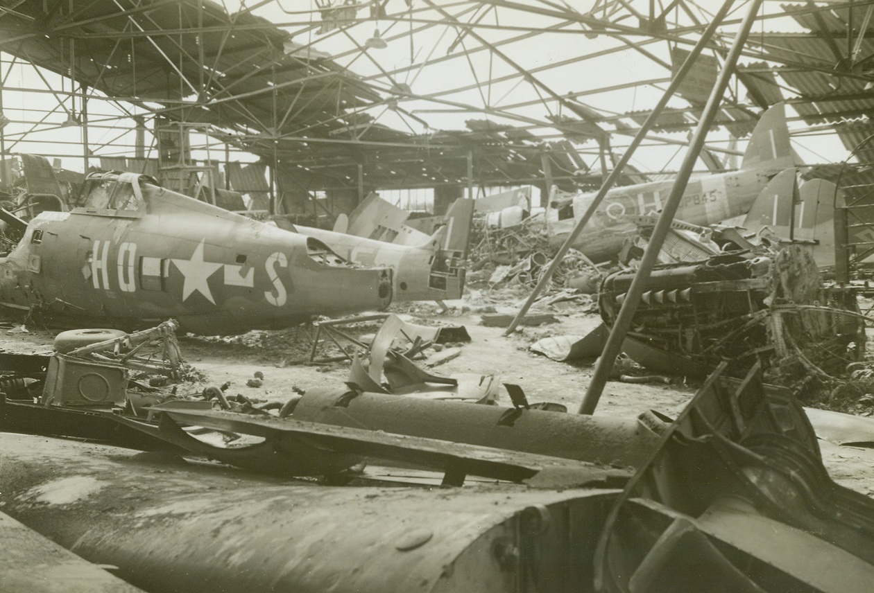 Allied Planes Stripped by Germans for Parts, 9/15/1944. Paris, France -- In this bombed hangar near Paris, the Germans kept downed Allied planes so that parts could be salvaged for their own aircraft. Spitfires and a P-47 Thunderbolt can be seen, partially stripped. Credit: ACME photo by Charles Haacker, War Pool Correspondent;