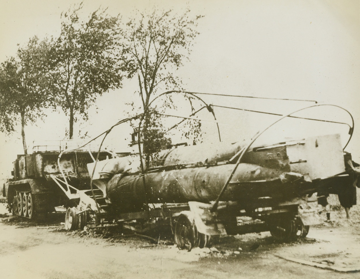 Safer on Land, 9/13/1944. Arras, France -- Apparently convinced that their subs are more safe on land than at the mercy of accurate Navy guns, the Nazis were carrying this midget submarine in overland flight when the British stopped them. Abandoned on a bombed-up road leading to Arras, the vessel still carries two unexploded torpedoes. This is a British official photo and has been passed by the British censor. Credit: ACME;