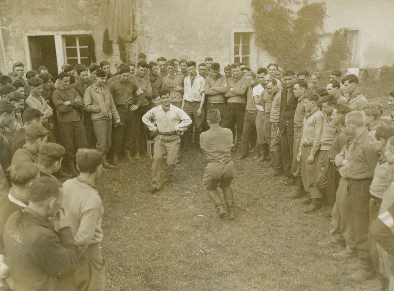Russians Dance for FFI Group, 9/30/1944. Belfort, France – In the vicinity of Belfort, Russian soldiers who were captured by the Germans at Stalingrad and were made to fight with them, entertain members of the FFI with a Russian dance after their escape from the Germans. They killed 40 Nazi officers and senior non-coms of their outfit and joined the FFI in their fight to drive the Germans from France. Credit: ACME photo by Thomas Shafer, War Pool Correspondent;