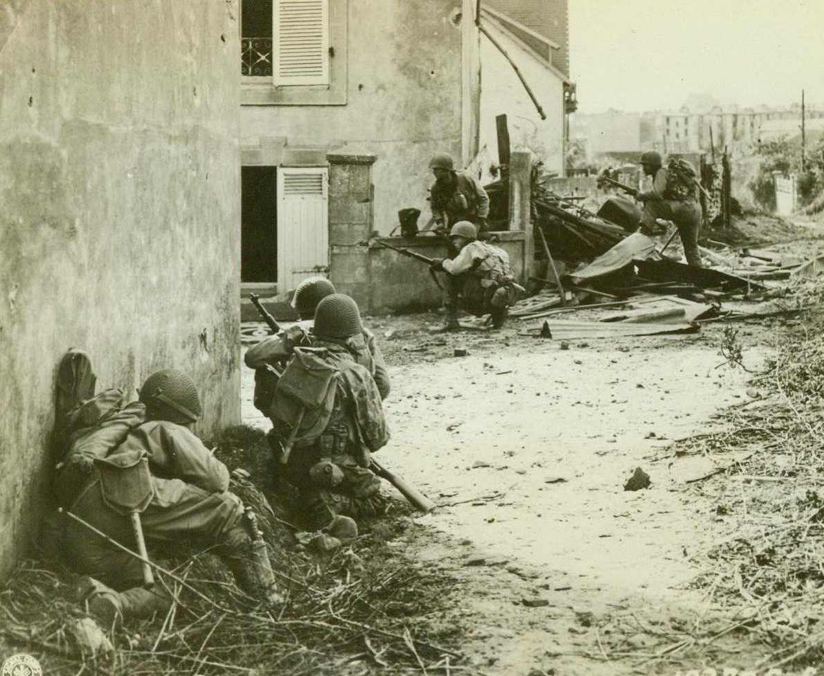 Yanks Hunt Snipers, 9/14/1944. France— In the outskirts of Brest, Yank infantrymen creep up on the enemy. The soldiers hug the walls of buildings and take whatever cover they can to keep out of the hail of machine gun fire Nazis are shooting their way. Enemy has desperately defended the vital submarine base.  9/14/44 (ACME);