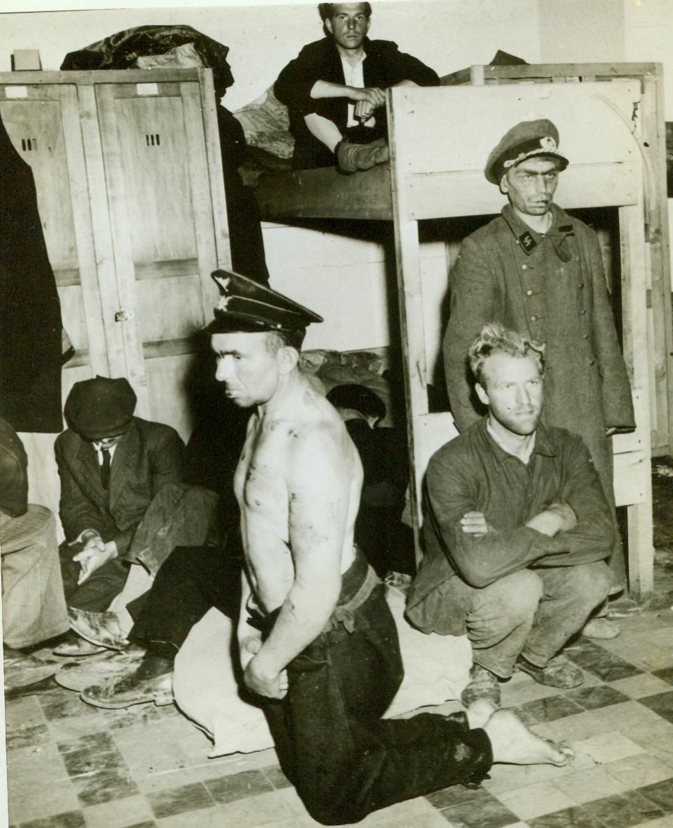 Judgment Day, 9/13/1944. Belgium—The day of reckoning is at hand for this mean-looking trio of disloyal Belgians. Rounded up by the F.I.N. (Front Independent of Namur), Belgian resistance group, they await trial for treason and other charges. Kneeling in foreground is the Mayor of Olloy, who worked with the Gestapo. The sorry little man in background wears a Nazi cap and overcoat sizes too big for him 9/13/44 Acme;