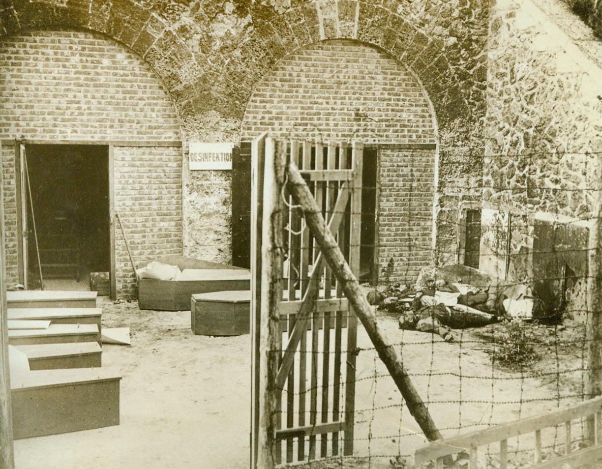 The French Don't Forget, 9/8/1944. Paris -- Memories of this - The burying place at Fort Du Romainville for French civilians who were cruelly mutilated by the Germans and other Nazi atrocities brought the work of the French underground in Paris to a head, and they rose as a body to wrest their city from the enemy, without thought of outside aid. Note the unburied bodies still lying in the rear of the courtyard in this picture, made by an FFI photographer during the week before Paris fell, when the French Forces of the Interior were fighting without any Allied assistance to wrest their Capital from the Germans.  9/8/44 (ACME);