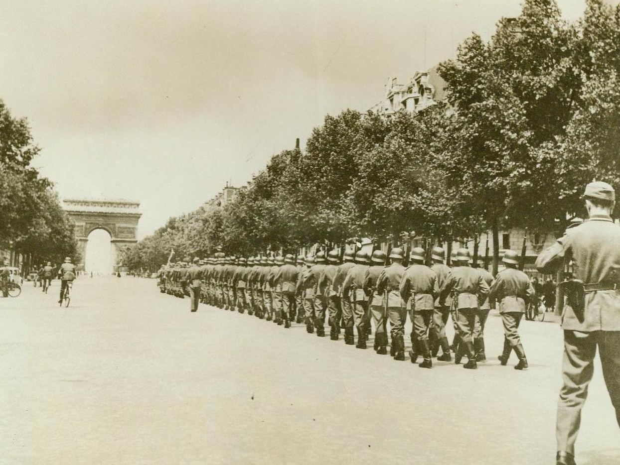 Footsteps That Now Are Only An Echo,  9/8/1944. Paris -- Unaware that they were treading this route for the last time, German soldiers goose-step down the Champs Elysees toward the Arc De Triomphe, in the last parade of their might before the liberation of Paris. This picture, made by a member of the FFI, was taken during the week before Paris fell, as the first stirrings of the underground began to take form in street fighting and assaults on the Nazis, to be climaxed by the wresting of the French capital from the hated Germans. 9/8/44 (ACME);