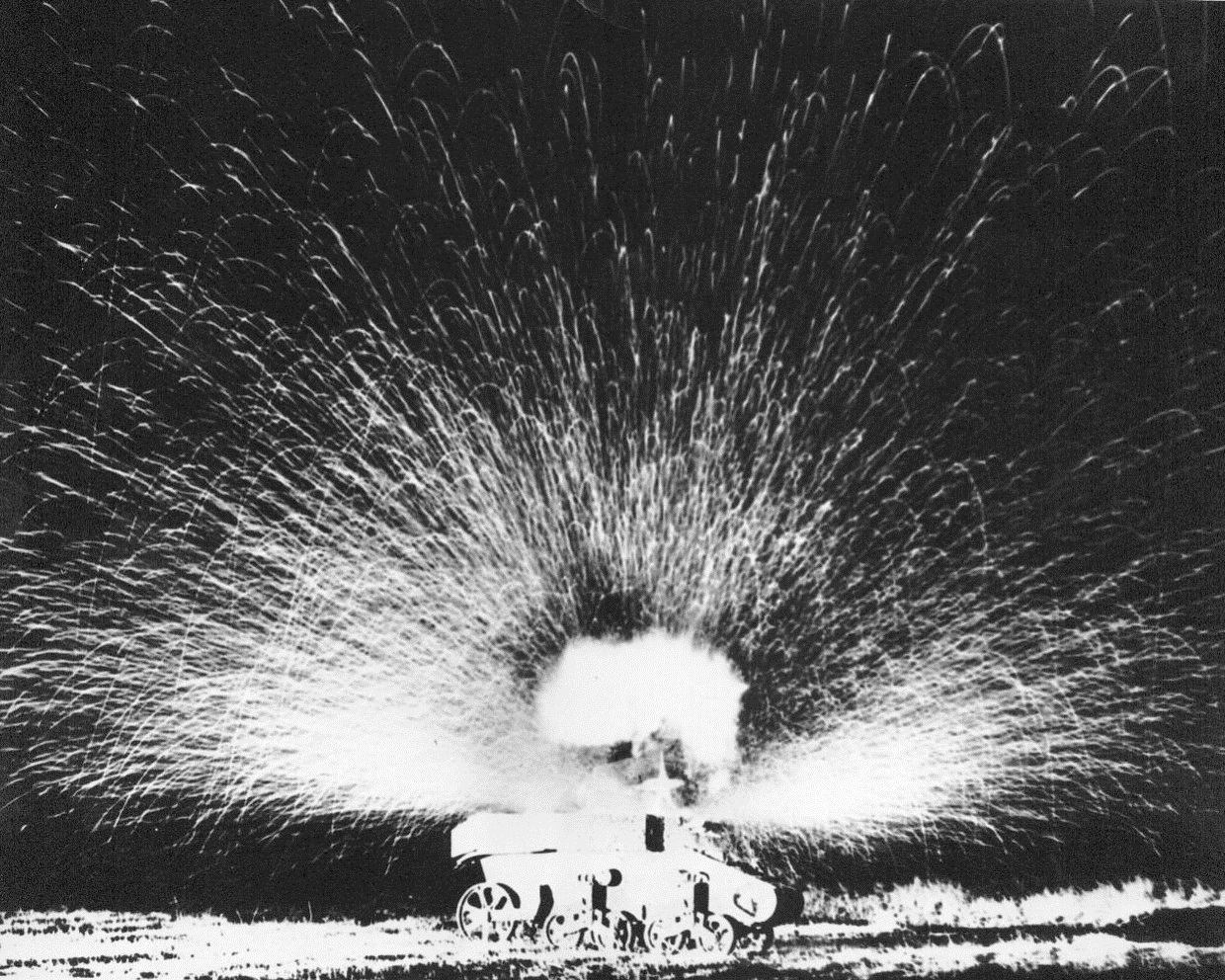 Bazooka Plays a Deadly Tune, 9/12/1944. Sparks fly in all directions in a display of pyrotechnics caused by the deadly power of the "Bazooka." A single high explosive rocket sends a shower of moltenmetal into the night and leaves a three-inch hole in the armor planting of the tank during exhibition at Camp Roberts, Calif.;