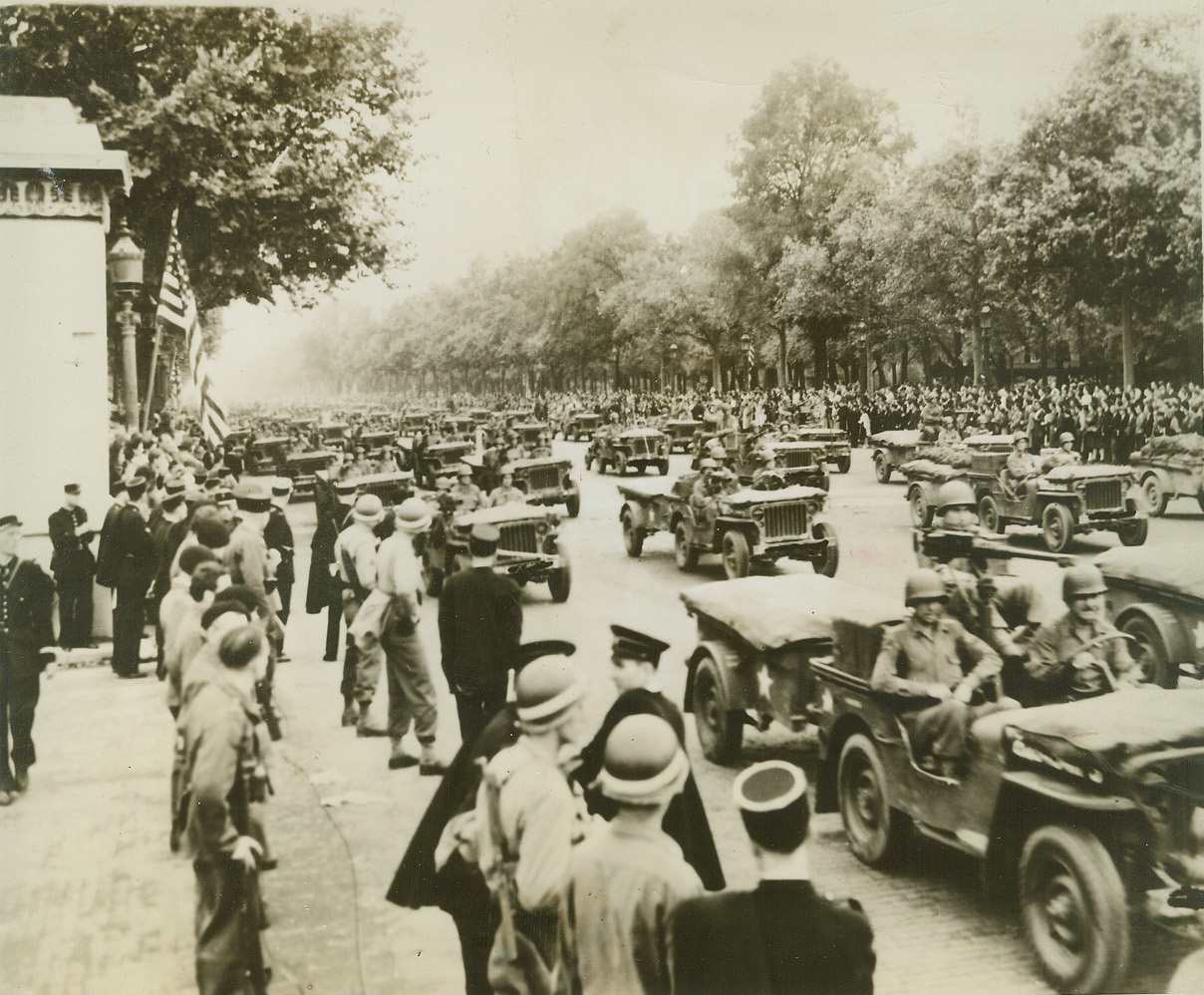 American Jeeps See Paris, 9/3/1944. PARIS -- Spaced out across the wide Paris street, American Jeeps with trailers participate in the grand parade of US troops and mechanized units on August 29. Civilians line the streets, eager to view their liberators. Credit (ACME) (WP);