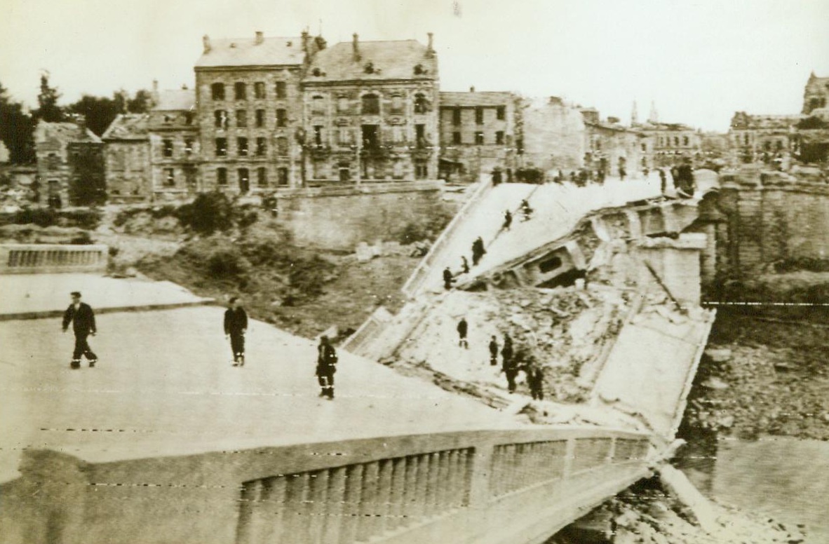 Perilous Crossing, 9/4/1944. Chalons, France—Retreating Germans blew up this bridge, spanning the Marne River at Chalons, but that didn’t stop the French. It’s a perilous crossing, but civilians manage to pick their way over the wreckage to get to the other side 9/4/44 (Army Radiotelephoto From ACME);