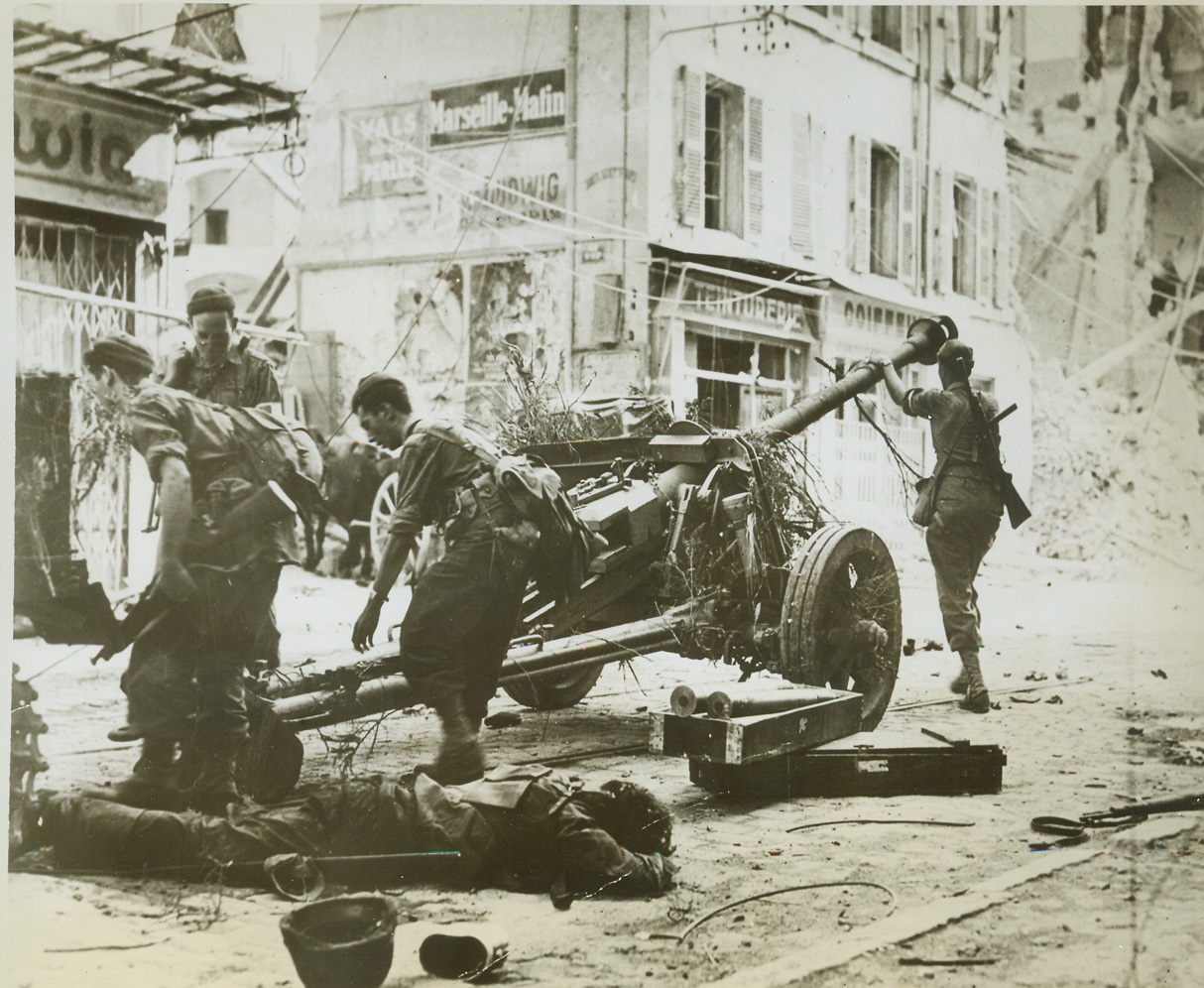Nazi Gun Put to Use by Allies, 9/9/1944. France—A captured Nazi gun is wheeled about to face remnants of German forces which had been holding out against French troops in Toulon. In foreground is the body of a dead Nazi gunner. Credit: U.S. Navy photo from ACME;