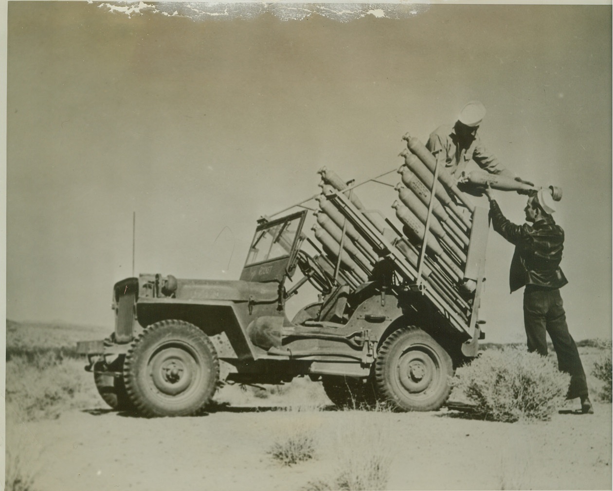 Fire Rockets From Jeep, 1/26/1945. InYokern, Calif. – At the Inyokern, Calif. government reservation where Navy and Marine Corps Air and ground crew forces train, engineers are experimenting with all possible methods in the use of the rocket. This Jeep has been turned into a launching platform. Reservation, which is 1025 square miles in area, is used as a testing ground for the rockets.  Credit (U.S. Navy Photo from ACME);