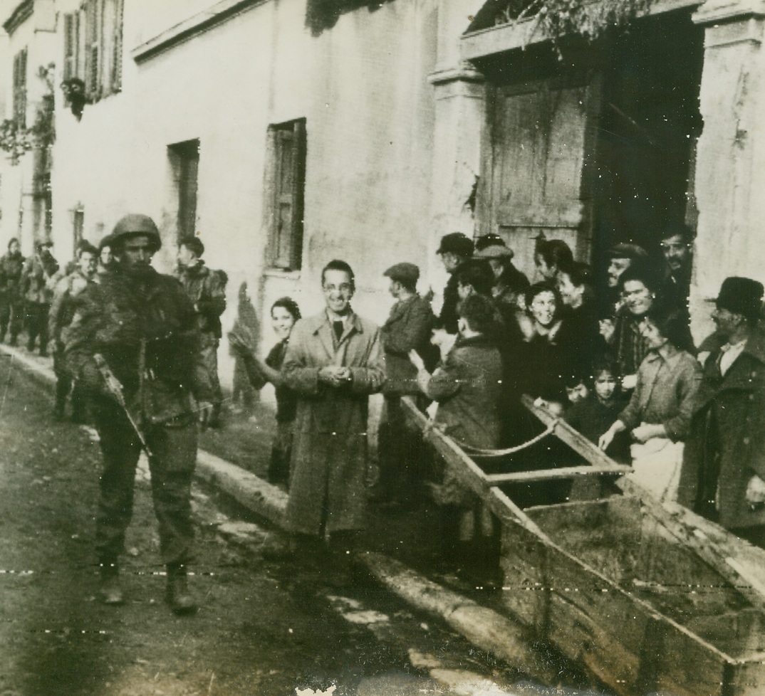 Greeks Applaud British Paratroops, 1/1/1945. ATHENS, GREECE -- According to the British caption accompanying this photo, Greek civilians smile and applaud as British paratroopers move in on the gas works at Athens on Christmas Eve. Credit (British Official Photo Via OWI - ACME);