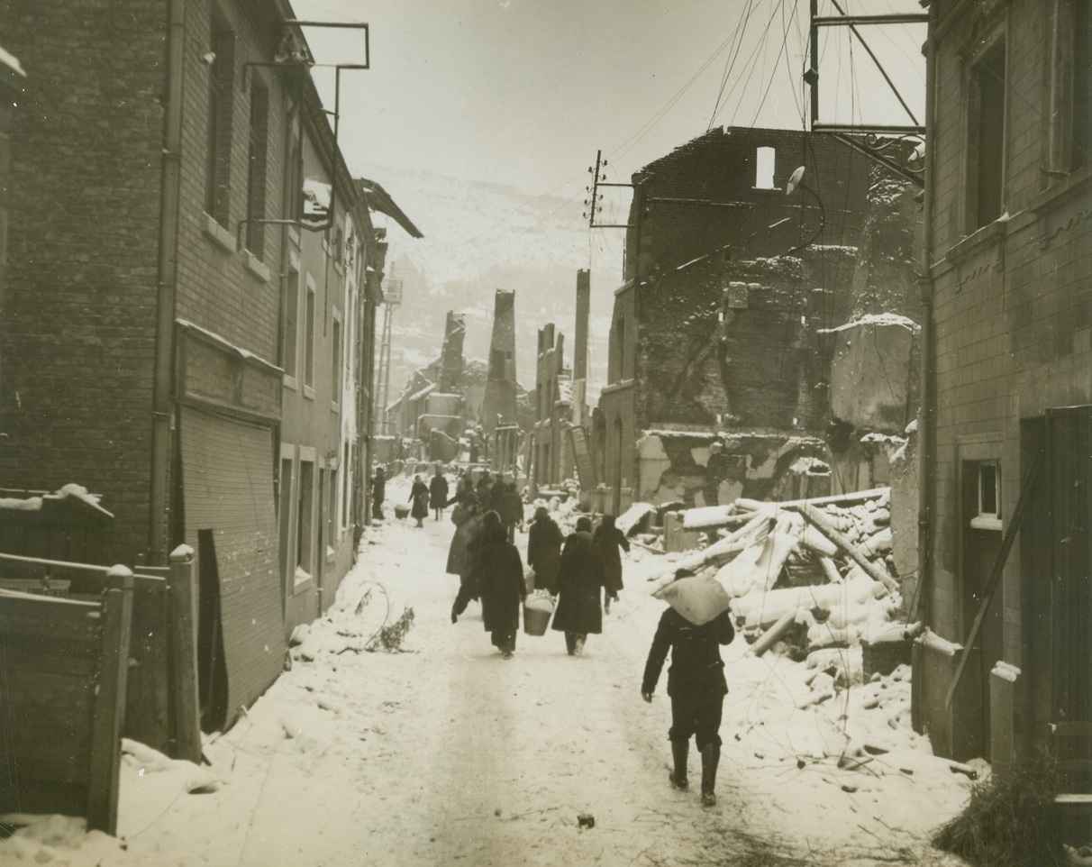 Home Again, 1/19/1945. BELGIUM – Driven into the hills when the Nazis invaded their town, residents of La Roche came home after Americans had forced enemy into retreat. Photo by Acme Photographer, Harold Siegman, for the War Picture Pool.Credit – WP- (Acme);