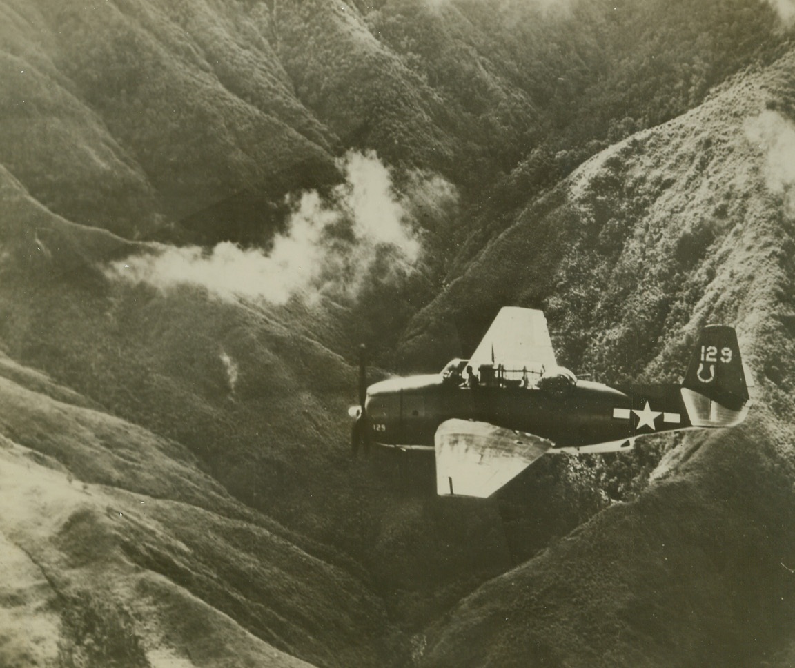 Strike at Japs on Luzon, 1/12/1945. Phillipines – Snapped against the sombre background of a deep crevasse in the mountains of Luzon, a Navy General motors avenger torpedo bomber roars on its course during an aerial strike at Jap shipping in the Phillipines.Credit (U.S. Navy photo from ACME);