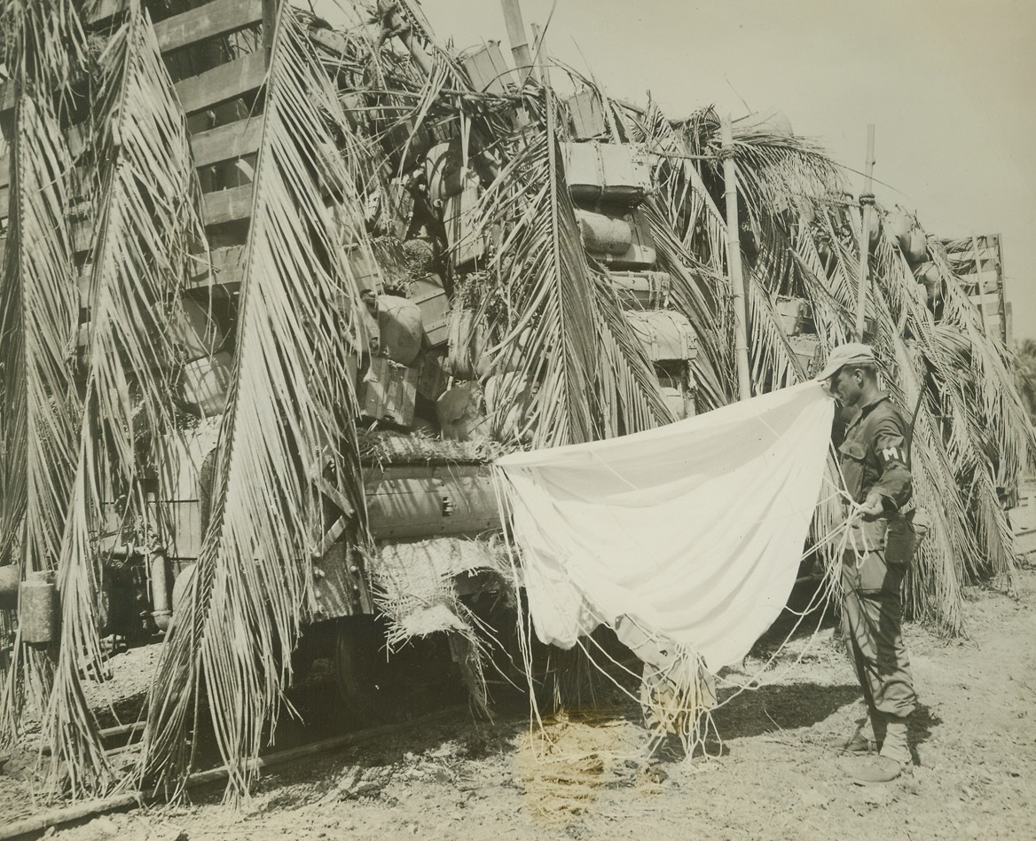 No Title. 1/23/1945. Sgt. Paul P. Pogkoski examines a Japanese parachute.  The chute was one of many found in the box car by the Yanks.  Photo by Stanley Troutman, ACME photographer for the War Picture Pool.Credit Line -WP- (ACME);