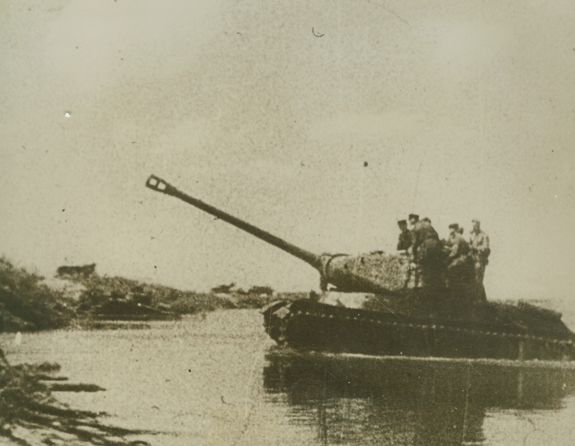 New Stalin Tank, 1/24/1945. Russian soldiers stand on the turret of the new Stalin Tank as it fords a river during a drive on the Eastern Front. According to German sources the tank weighs approximately 50 tons, has a 122mm. gun, three machine guns and armor roughly 4 inches thick.Credit: British Official Photo from ACME;