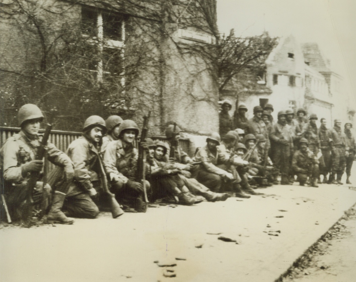 YANKS CAPTURE COLOGNE, 3/6/1943. GERMANY—Troops of the U.S. 1st Army, get a well-earned rest in a back street in Cologne, after forcing their way into the Rhineland capital. Announcement late tonight, said they had captured the city.Credit: Acme photo via Army Radiotelephoto;