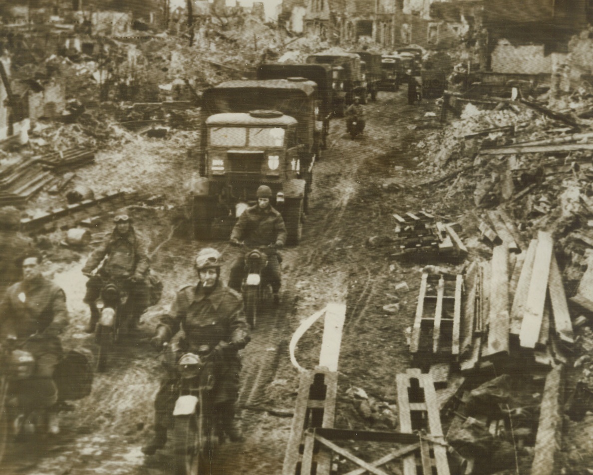 On the Road to Munster, 4/3/1945. GERMANY—British troops and transports go streaming towards Munster through the ruined, rubble-strewn German town of Stadtlohn. Credit: OFFICIAL BRITISH RADIOPHOTO-ACME.;