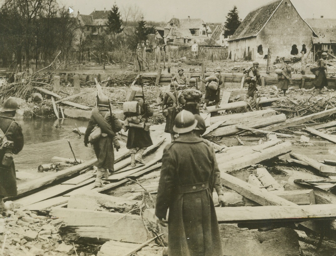 Tunisian Troops in Germany, 4/2/1945. GERMANY – Tunisian troops of the French Army cross improvised wooden bridge spanning the Lauter River to enter Germany. Crossing was made into city of Schriebenhardt. This was first time members of the French Army had entered the Fatherland.Credit – WP – (ACME);