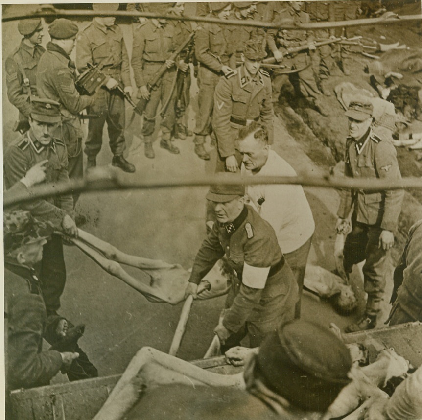 Remove the Dead for Burial, 4/27/1945. GERMANY – SS troops who had been posted at Nazi concentration camp at Belsen, Germany, load trucks with the bodies of their victims for transportation to burial grounds. British Second Army soldiers, who liberated the camp, look on with disgust and horror as Nazis lift emaciated bodies of the dead onto trucks. Credit (British Official Photo from ACME);