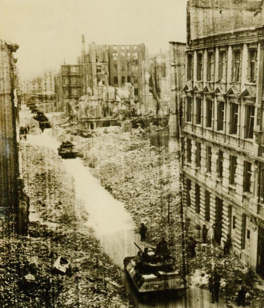 Yanks Enter Magdeburg, 4/18/1945. Germany – This photo, flashed to New York by radio tonight, shows tank destroyers and men of the 30th Infantry Division, U.S. 9th Army, moving up a rubble-strewn street in Magdeburg, as the Yanks captured the city. The buildings show the effect of the terrific battle fought there. 4/18/45 (ACME);