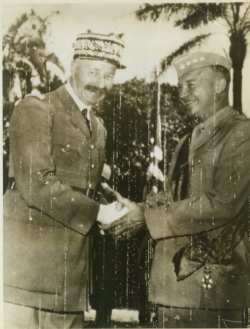 GENERAL IKE GETS RIBBONS AND A HANDSHAKE. ALLIED FORCE HQ., N. AFRICA – Bedecked with the Legion of Honor Medal, General Dwight D. Eisenhower, Commander-In-Chief of Allied Forces in North Africa (right) returns the congratulatory handshake of General Henri Giraud after the presentation at Allied Force Headquarters. Credit: OWI Radiophoto from ACME;