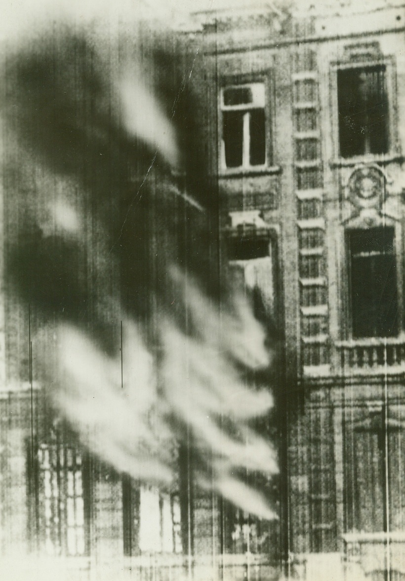 No Title. Set on fire by German bombers, building blazes in Namur, Belgium, towards which Nazi forces were driving today. (Cablephoto London);