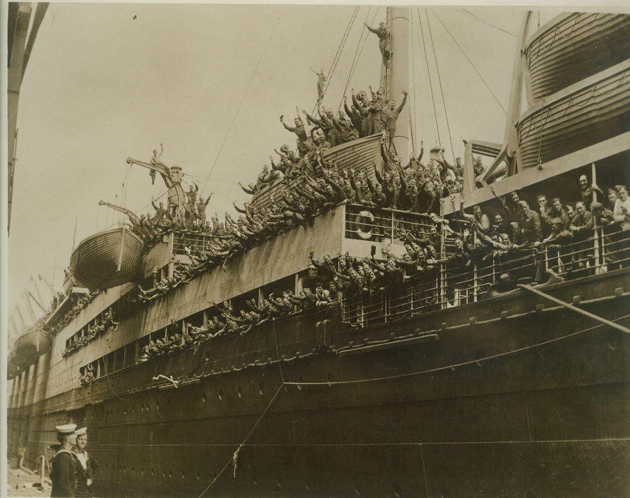 Canadians Sail for Britain. AT A CANADIAN PORT -- A fresh batch of Canadian reinforcements for England, is shown waving good-bye as their ship eased out of its berth from an East Coast port. Credit: (ACME);