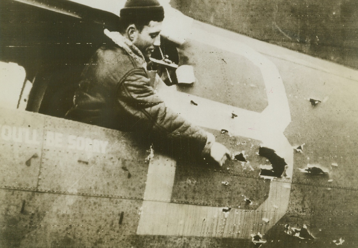 Flak holes made on mission over Germany.;