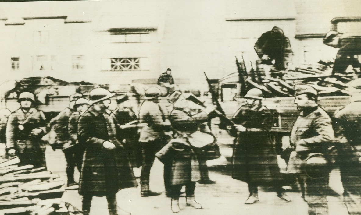 No Title. [caption mostly illegible] Belgian troops giving up their arms after King Leopold’s…;