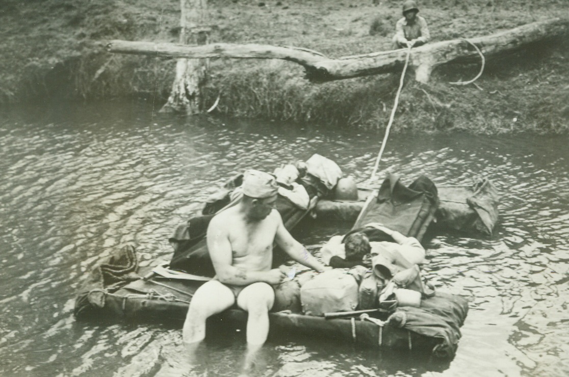 No Title. When additional treatment is required patients are transported to the portable hospitals which are often no less than 800 yds to the rear and streams have to be crossed as shown here with Sgt. W.H. Manley attending 2 men while another member of the medical detachment aids in ferrying raft across stream.  Signal Corps photo from ACME;