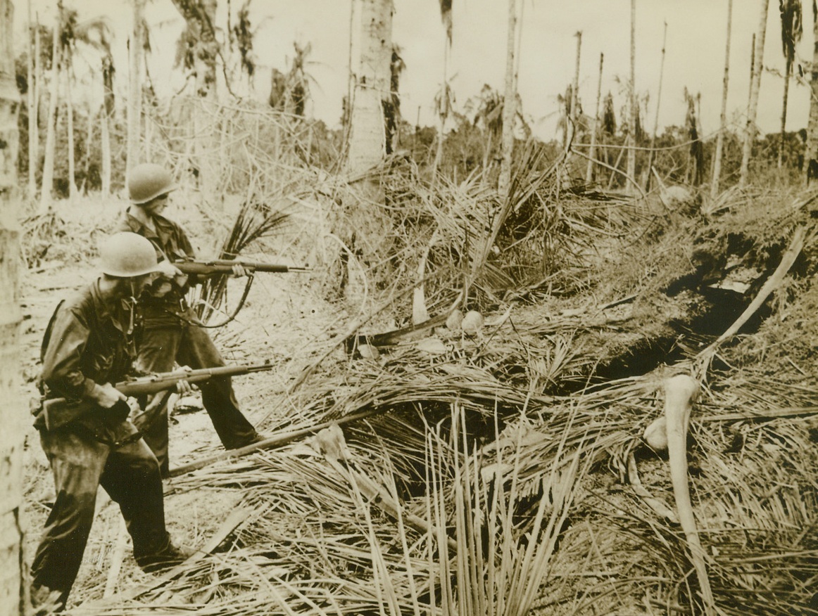 Americans Inspecting a Jap's Hole...New Guinea.