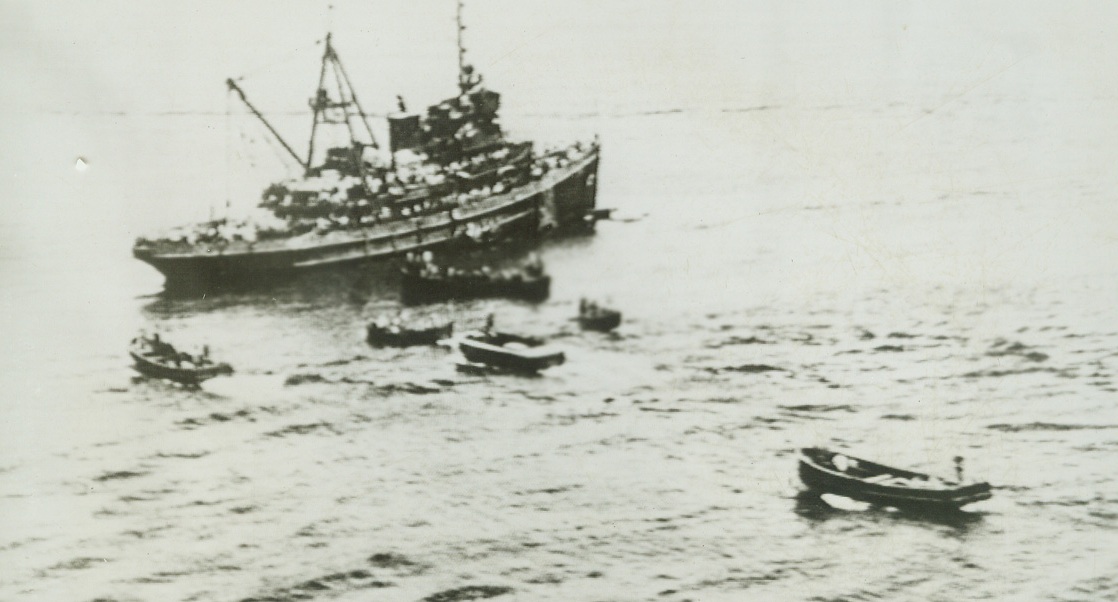 No Title. A U.S. Navy auxiliary vessel, already packed with rescue men, stands by to pull still more of them from oily waters, where their vessel, a U.S. Army transport (formerly the S.S. President Coolidge) went down after striking a mine in the Solomon Islands area. Other small boats bearing survivors, also take part in the rescue work. Credit: OFFICIAL U.S. NAVY NEWSREEL POOL FROM ACME TELEPHOTO;