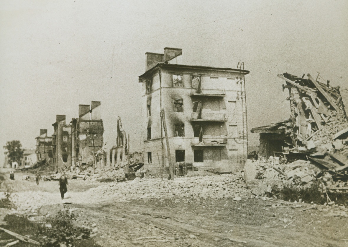 Blasted Orel is Recaptured. Orel, Russia – This is the scene that met the returning residents of Orel, when Red troops liberated the city in their crushing drive against the Germans. Gaunt, fire-scarred walls mark what had been a block of modern apartment buildings, (photo above), along Krasnoarmeiskaya Street (cq). (Passed by Censors).;