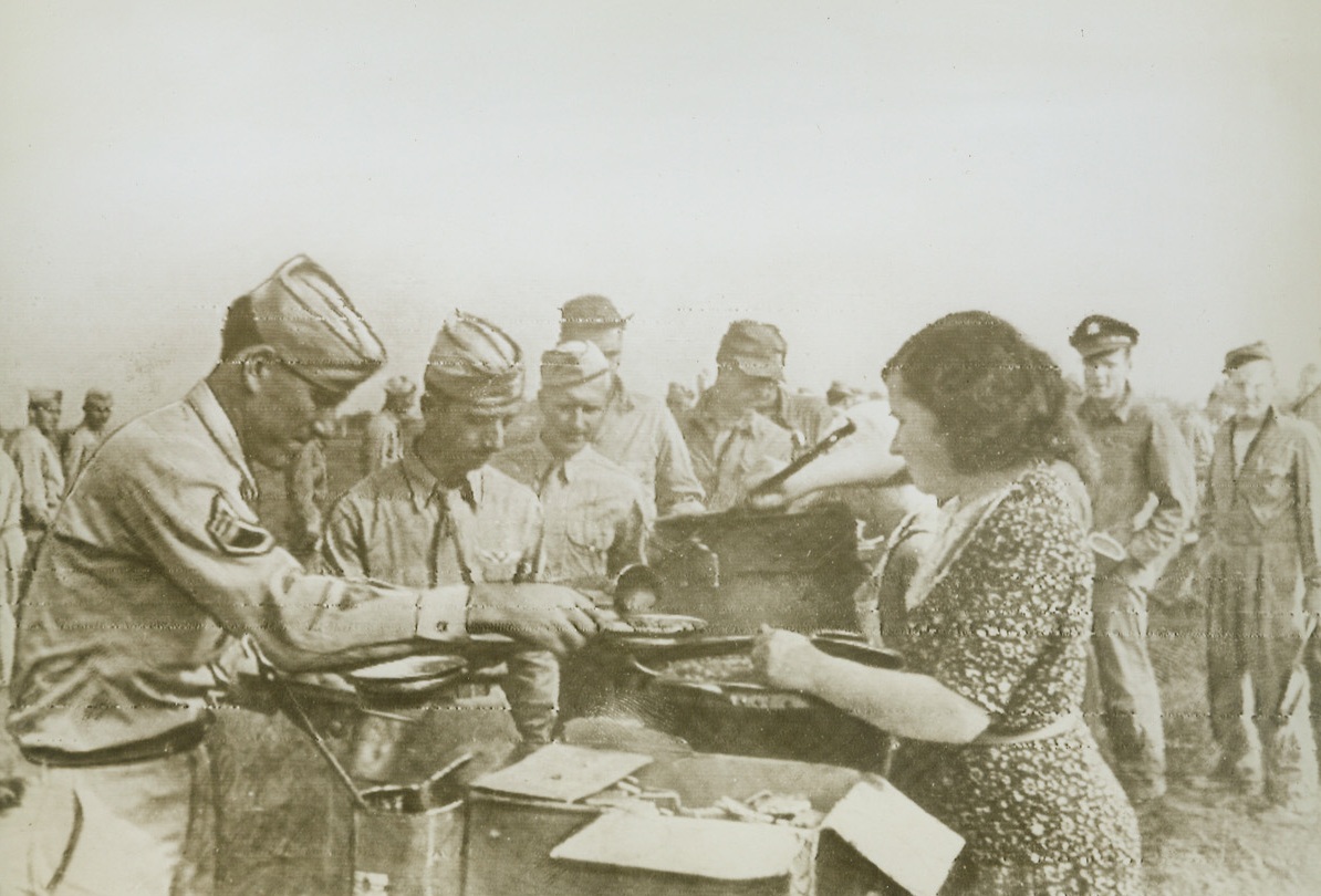 Yank Airfield in Russia. Russia – Shuttle bombing takes an a new and highly potent form now that it has been revealed that American airfields have been established in the Soviet Union. The first planes to land on the new fields were American “Flying Fortresses” after bombing enemy military targets in Romania. Soviet and American flyers – comrades-in-arms – are shown talking on one of the Aerodromes before a fighter plane. Credit: ACME Radiophoto;