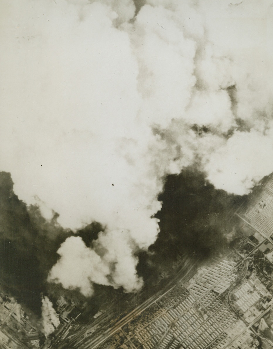 Debut of B-29’s. ANSHAN, MANCHURIA – Mountain-high clouds of two-tone smoke rises from the Showa Steel Works at Anshan, as bombs from B-29s, of the U.S. Army 20th Bomber Command, seek out their target on the debut raid of the Superfortresses on July 29. Anshan is Manchuria’s largest industrial city, 60 miles from Mukden. Credit: USAAF photo from ACME;