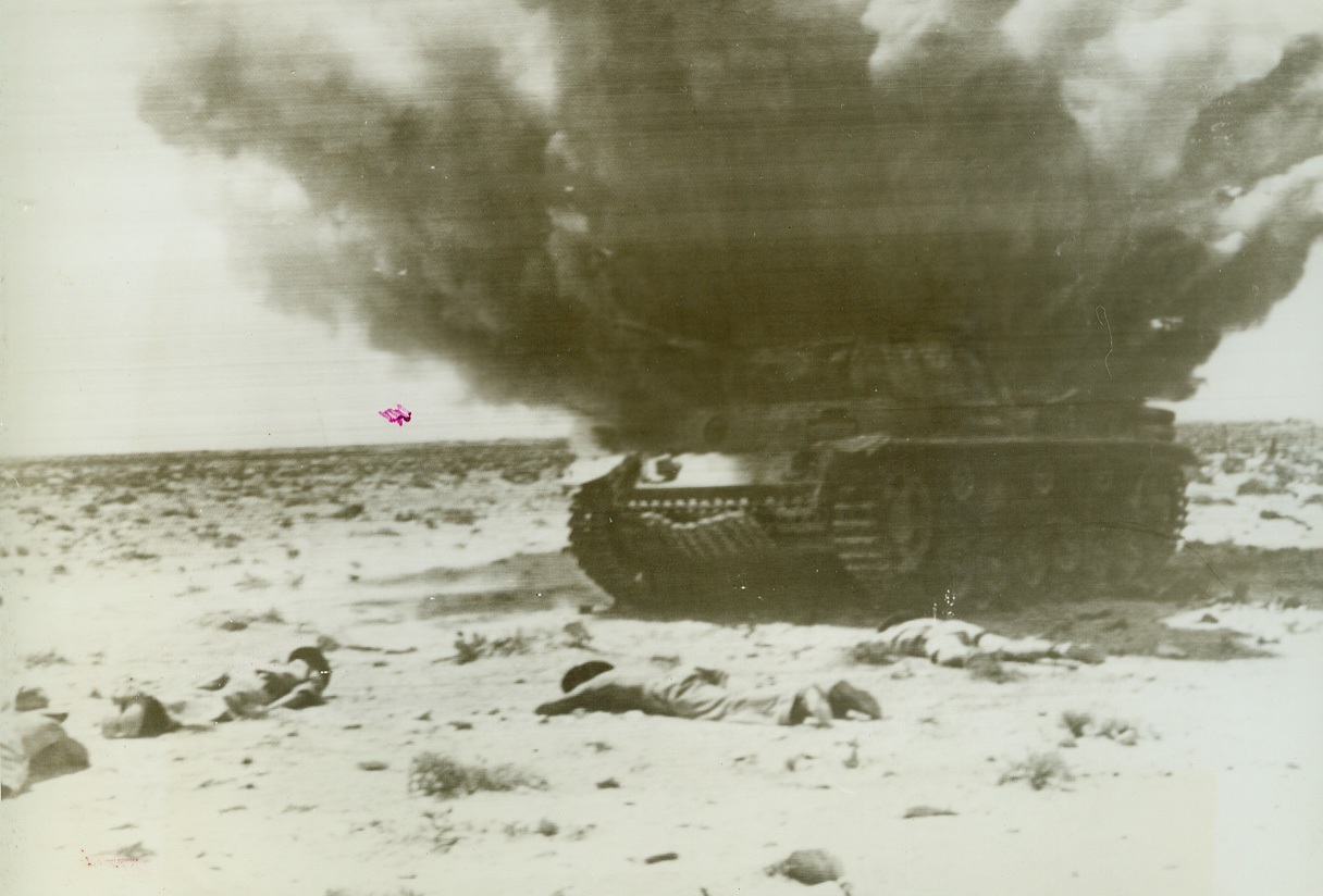 No Title. During lull preceding current British Egypt drive, Aussies throw selves on ground when ammunition bin in captured, smoldering German tank explodes.  Tank had been heavily strafed y RAF planes.  One of Aussies said “we went to earth in a hell of a hurry.”  No one was hit. No credit line shown;