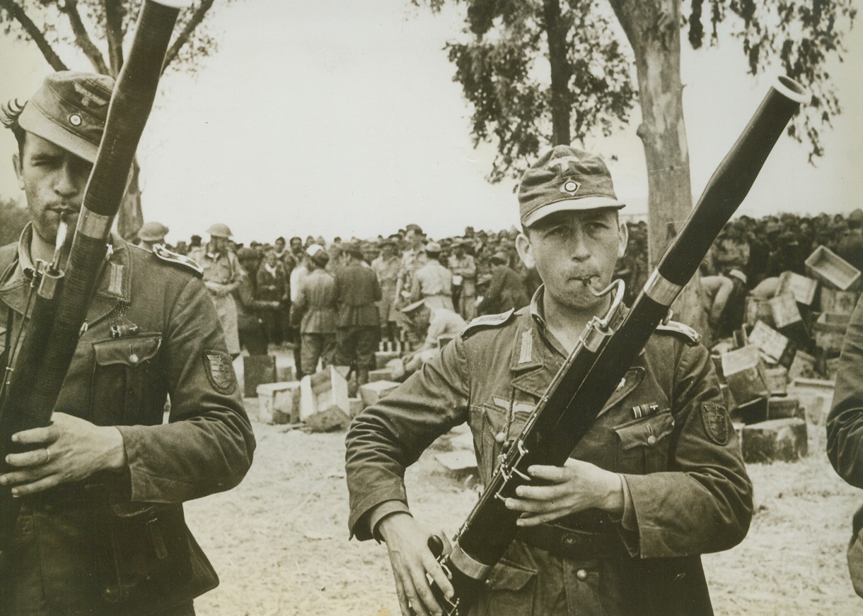 Blow, Blow, Blow.Somewhere in Tunisia—Given permission to blow their bassoons and make music to cheer their captured, war-weary comrades, these Nazi prisoners are wondering if it really was an ill wind that blew them into Allied hands. Life as a prisoner of the United Nations doesn’t seem half as bad as their Fuehrer painted it. A complete brass band was captured during the battle of Tunisia.;