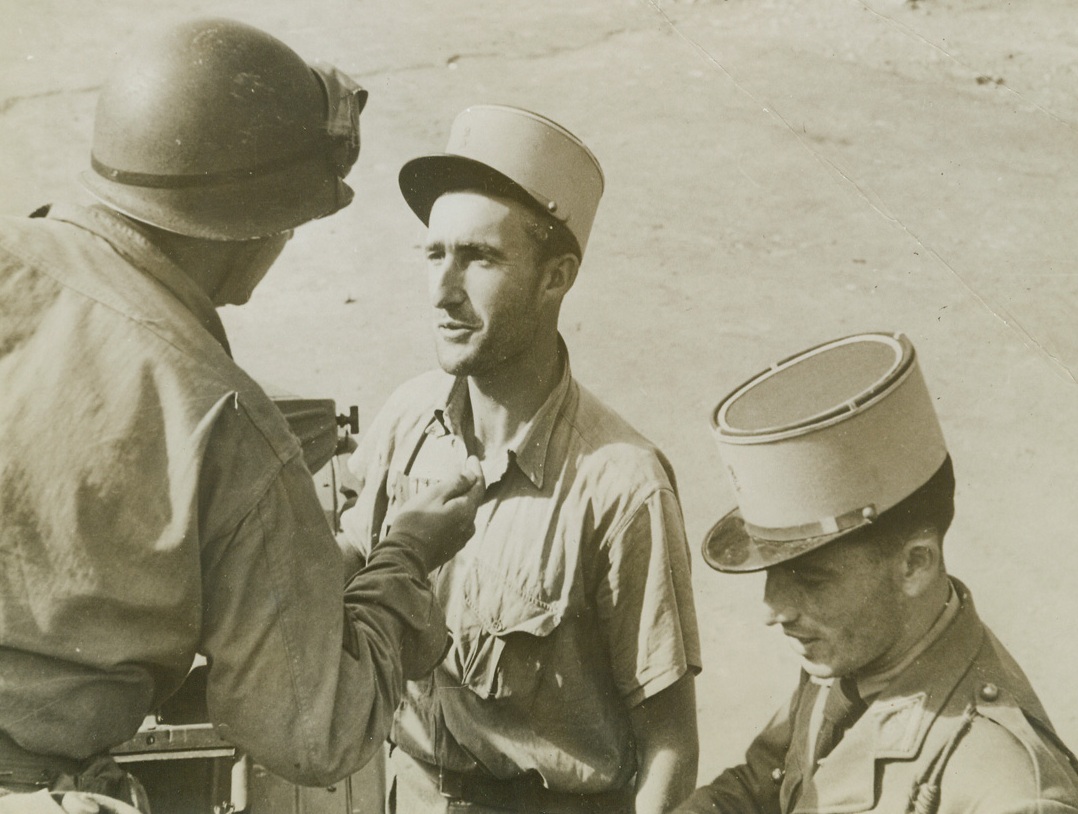 No Title. ...Morocco - American soldier checks identification of French soldier.;