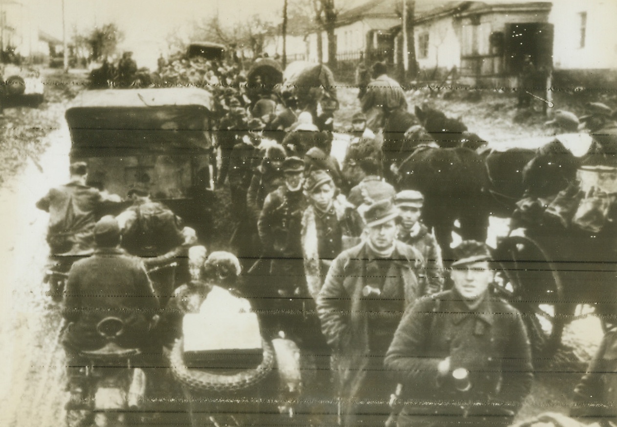 German Retreat. Cherkassy, Russia—Two German troop units are shown in the old Ukranian city of Cherkassy. One unit is retreating from the fast Red Army drive, while the other unit is moving frontward for rearguard action. The Red Army scored a victory which climaxed several weeks of operations of driving out the Germans from Cherkassy. Their last big stronghold on the middle of the Dnieper River. This picture was radioed from Stockholm. Credit: ACME.;