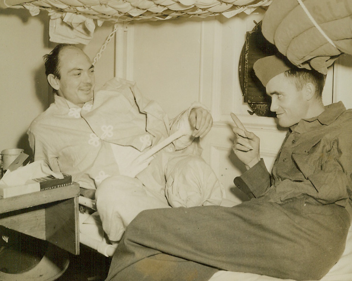 Southern Soldiers Return From Battle Fronts. These two wounded soldiers chat in a ward of the U.S. Army Hospital Ship “Aoadia” which docked Jan. 5 at an East Coast port returning casualties for treatment. Left is Sgt. Harvey Fitzgerald, 1858 Felix Ave., Memphis, Tenn.; Pfc. Raymond D. Horton, of Coleman, Tex. Is right.;