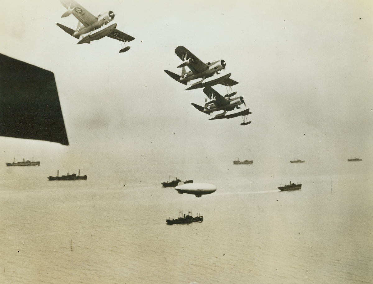 Ferreting Out Enemy Subs is Their Job. Atlantic – Roaring out over merchant ships loaded with supplies for the Allied Nations, U.S. Coast Guard Patrol Planes take up their positions around the fringes of the convoy. A Navy Blimp weaves over the Merchantmen as Coast Guard Cutters Sweep the shipping lanes.;