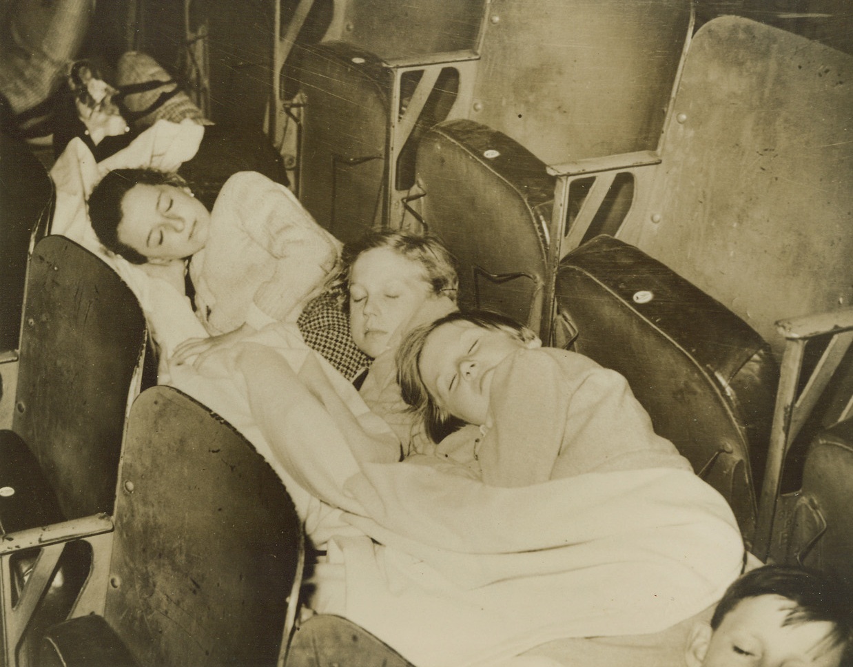 Theater of Rest. London – Weary Belgian refugee children sleeping on mattresses placed between rows of seats in London’s Empress Hall after a hazardous flight from their war-torn homes. (Photo flown to New York by Clipper) Credit: ACME;