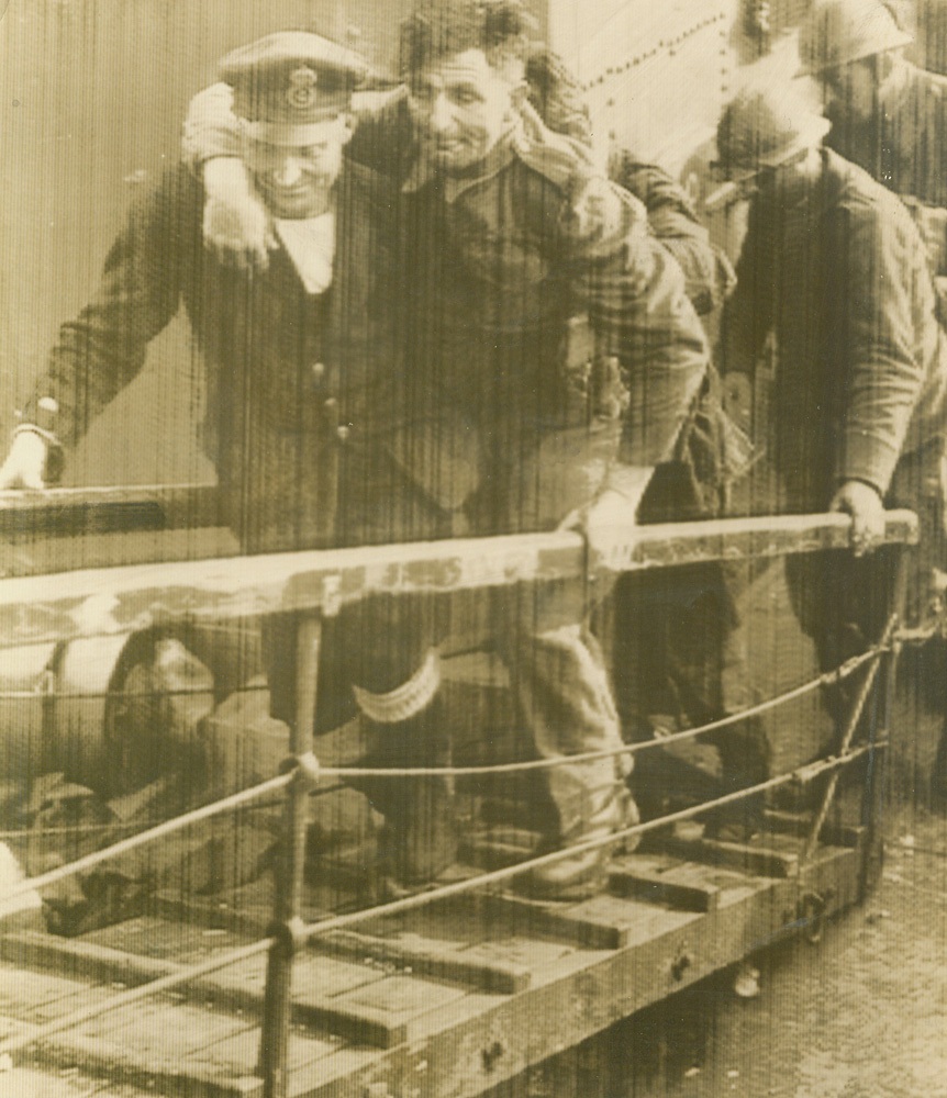 Wounded being carried aboard British hospital ship.
