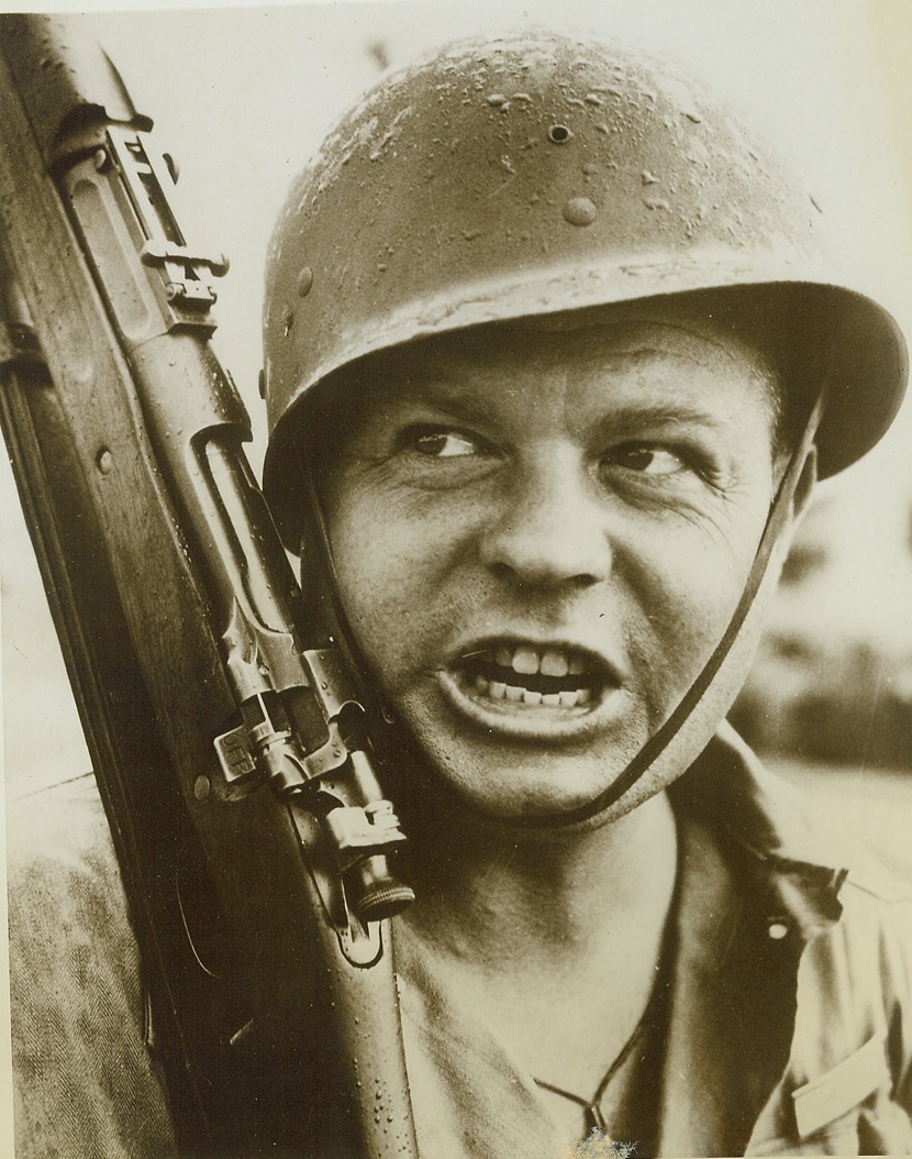 Toughened by Fire. CAMP DAVIS, N.C. – That’s no pose. Elmer Moody, officer candidate at the Antiaircraft Artillery School, Camp Davis, has got practical battle experience behind him. As an American volunteer in the Canadian Army, he participated in several raids on the French coast in 1941. He also saw action in France during 1940 and was right in the middle of the Battle of Britain, hammering away at the Nazis with an antiaircraft machine gun outfit on the coast of England. Last year, the soldier who used to be a Pasadena, Calif., lawyer, transferred to the U.S. Army. Credit (Official U.S. Army Photo for ACME);