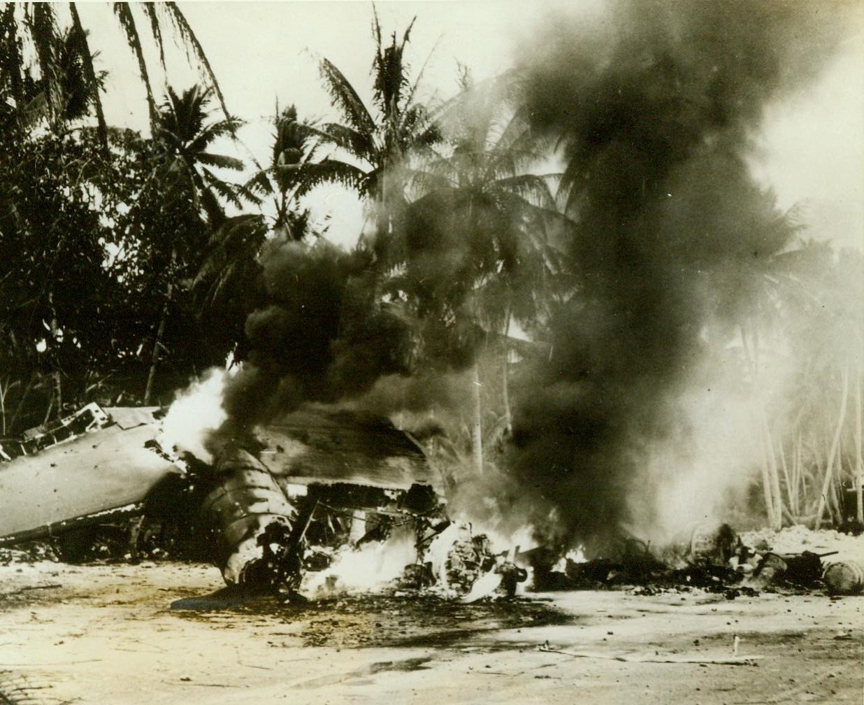 One-Half the Score. FUNAFUTI ISLAND, PACIFIC - This blazing B-24...is only one half of the score of damaged U.S. planes chalked up by the Japan...when they raided Funafuti Island the day...American Army bombers smashed at Nauru. Few casualties and the two bombers was...only damage done by the Nips when they...to smash timy Funafuti, the take-off...in the Ellice Islands for our...raid the previous day.;
