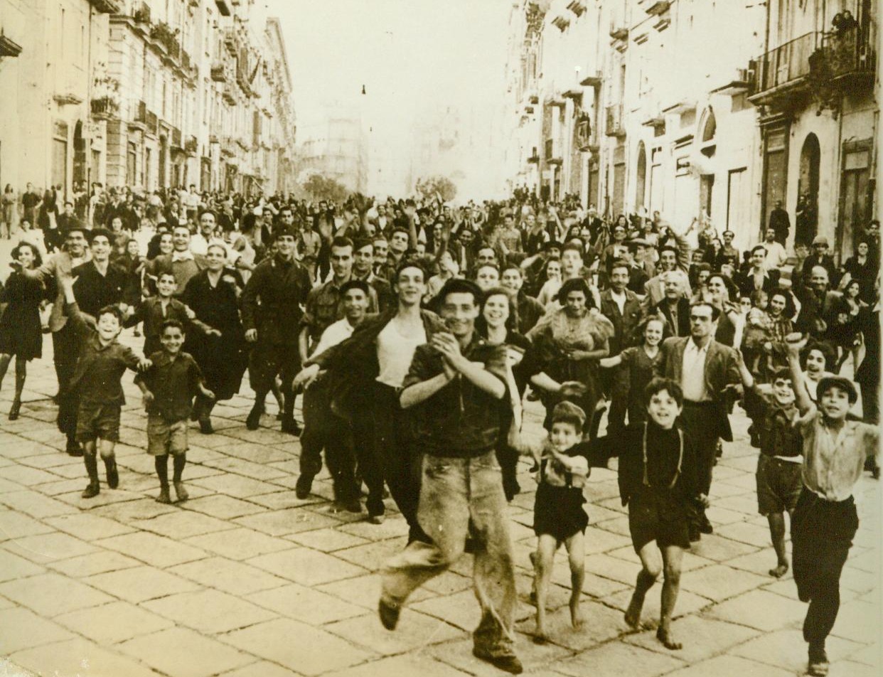 Cheering the Victors. Cheering The Victors Naples, Italy— Crowds of Neapolitans, many children among them, dash happily through a Naples street to greet men of the Allied Fifth Army as they enter the city. The first United Nations soldiers to reach Naples were given a hysterical welcome by civilians, young and old.;