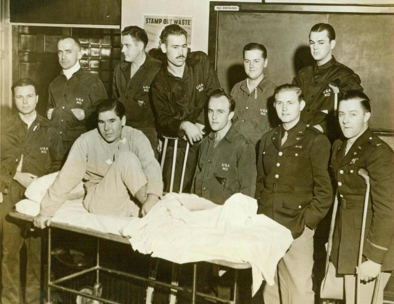 Back From Germany. Washington, D.C. – Ten of the 14 wounded American soldiers who were repatriated from Germany in an exchange of sick and wounded are interviewed at Walter Reed Hospital. Group around Corp. Rodney M. Graham (on cot) are (left to right) Sgt. Edwin N. Nelson, Marshall, Minn.; T/Sgt. Frank J. Bartnicki, Moosic, Pa.; S/Sgt. Milton K. Williams, North Platte, Neb.; Pvt. Robert M. Scott, Greensboro, N.C.; Pfc. Herbert L Ehrich, Brooklyn, N.Y.; Pvt. Leroy M. Keith, Denver, Pa,; First Lieut. Albert W. Glass, Jr., Macon, Ga.; S/Sgt. Norman C. Goodwin, Haverhill, Mass., and Second Lieut. Glen M. Harrington, Ogden, Utah. (ACME);