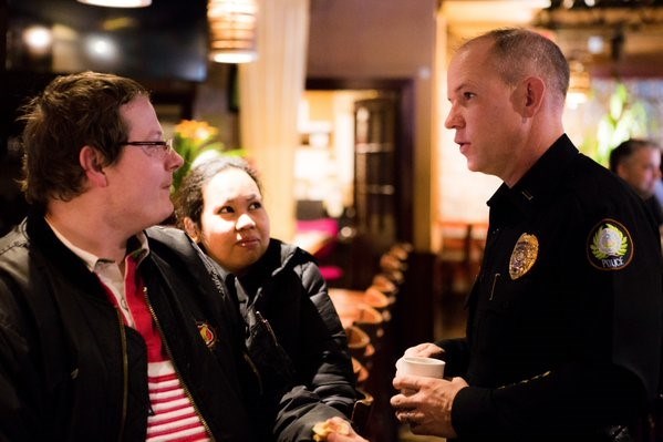 Lieutenant Steven McClanahan talks with citizens on neighborhood concerns