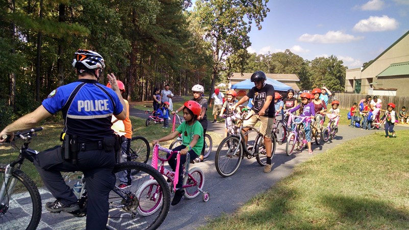 Photo of bicycle education, encouragement, and enforcement after receiving new, free helmets and bikes at Biki Fiesta 2017.